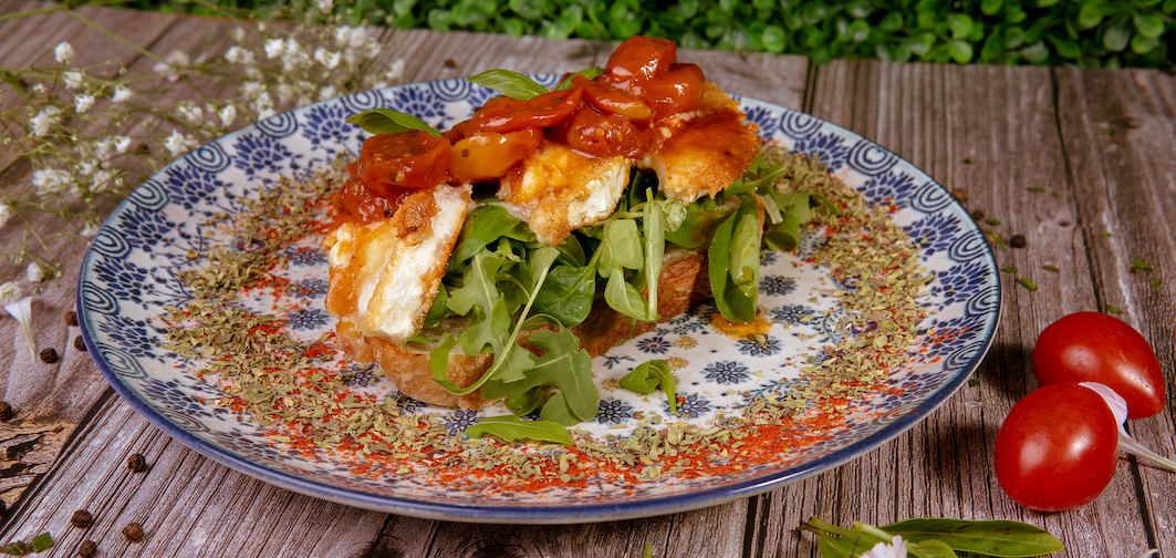 Rulo cabra flambeado, aguacate, tomate seco